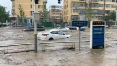 Heaviest rain in a decade kills 11 in Beijing as raging torrents wash away roads and cars